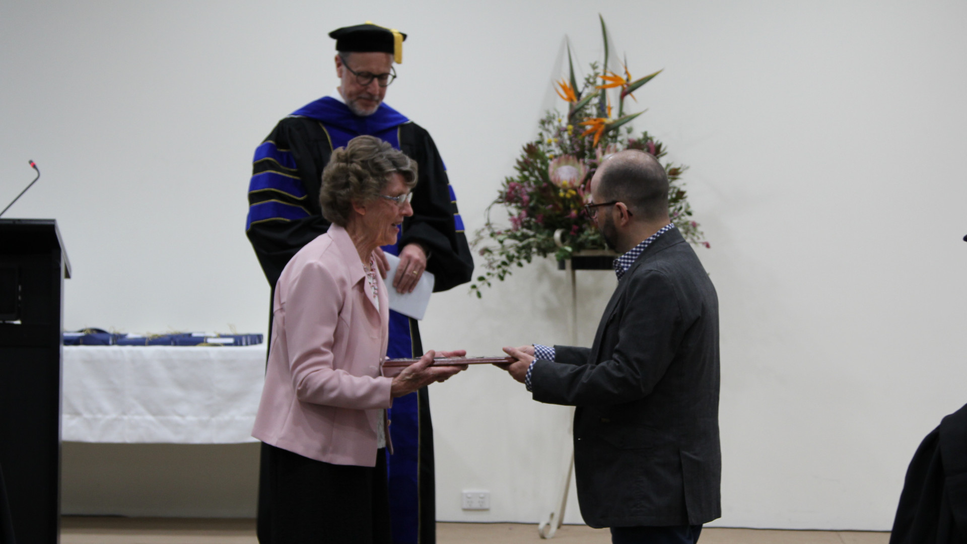 Andrew Grace receiving award from Margaret Rickard