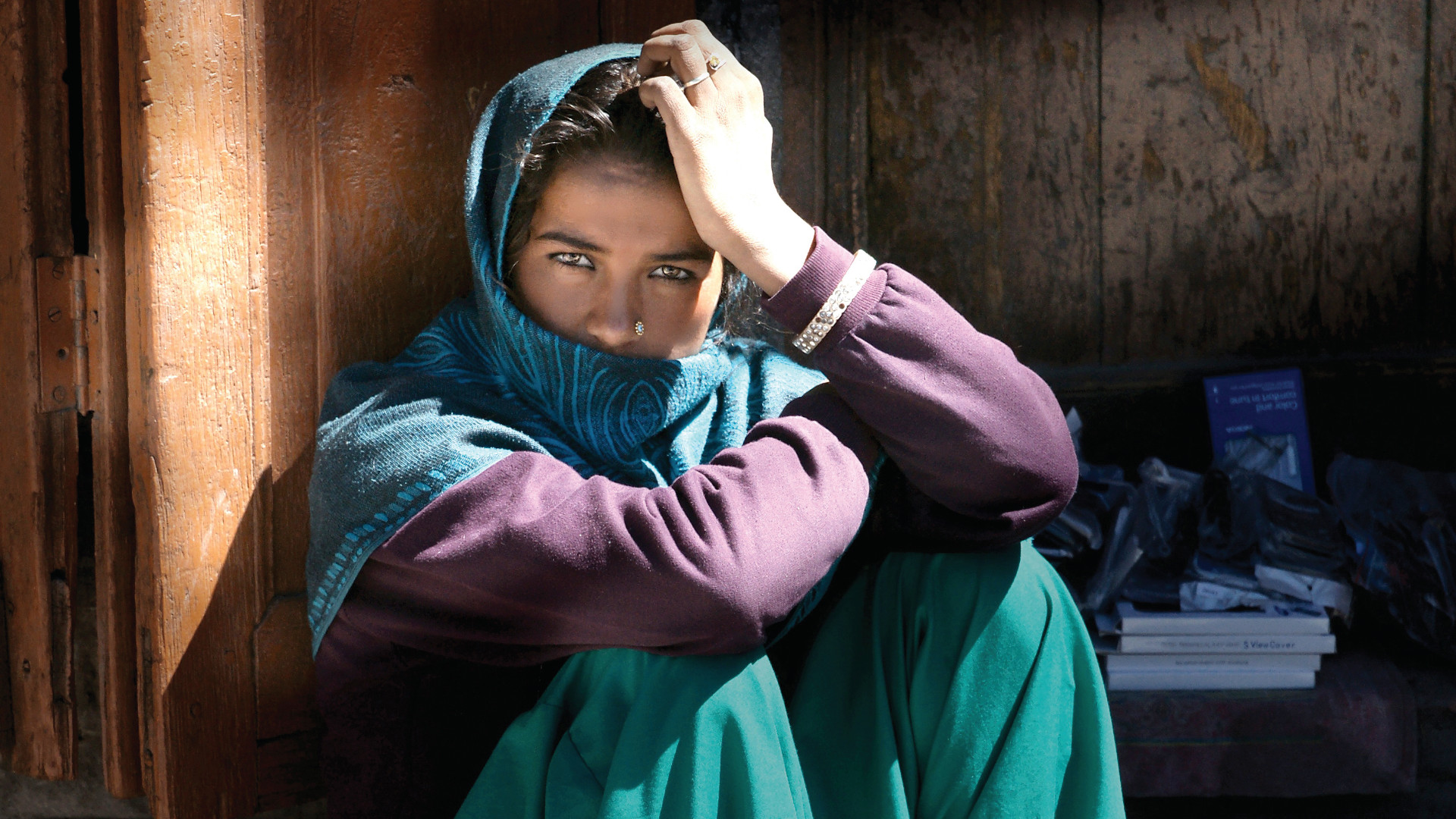 Middle eastern lady sitting with her face covered by a scarf